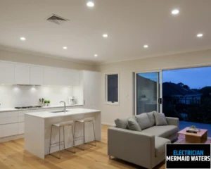 Bright and modern living room and kitchen area with a sofa, dining table, and large windows offering a view.